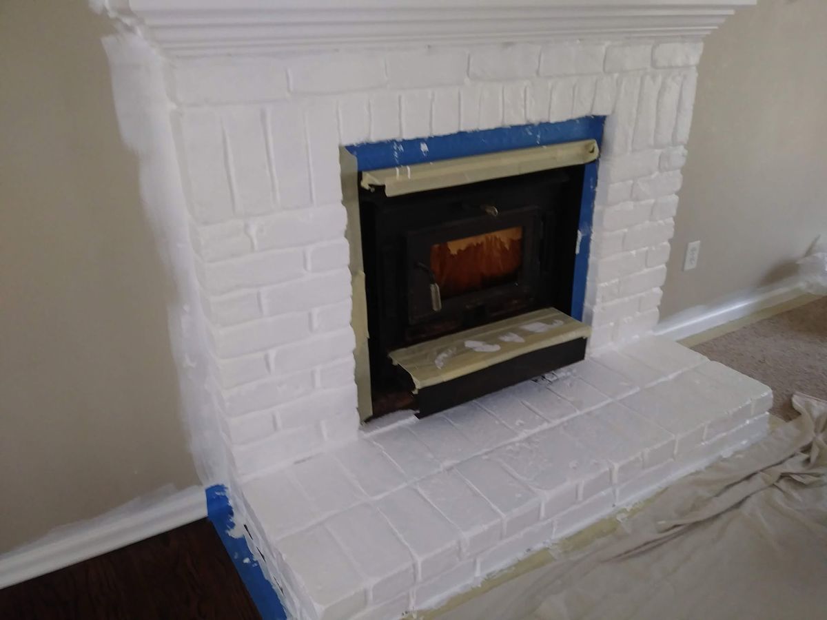 Brick fireplace surround painted, hearth and stove masked off
