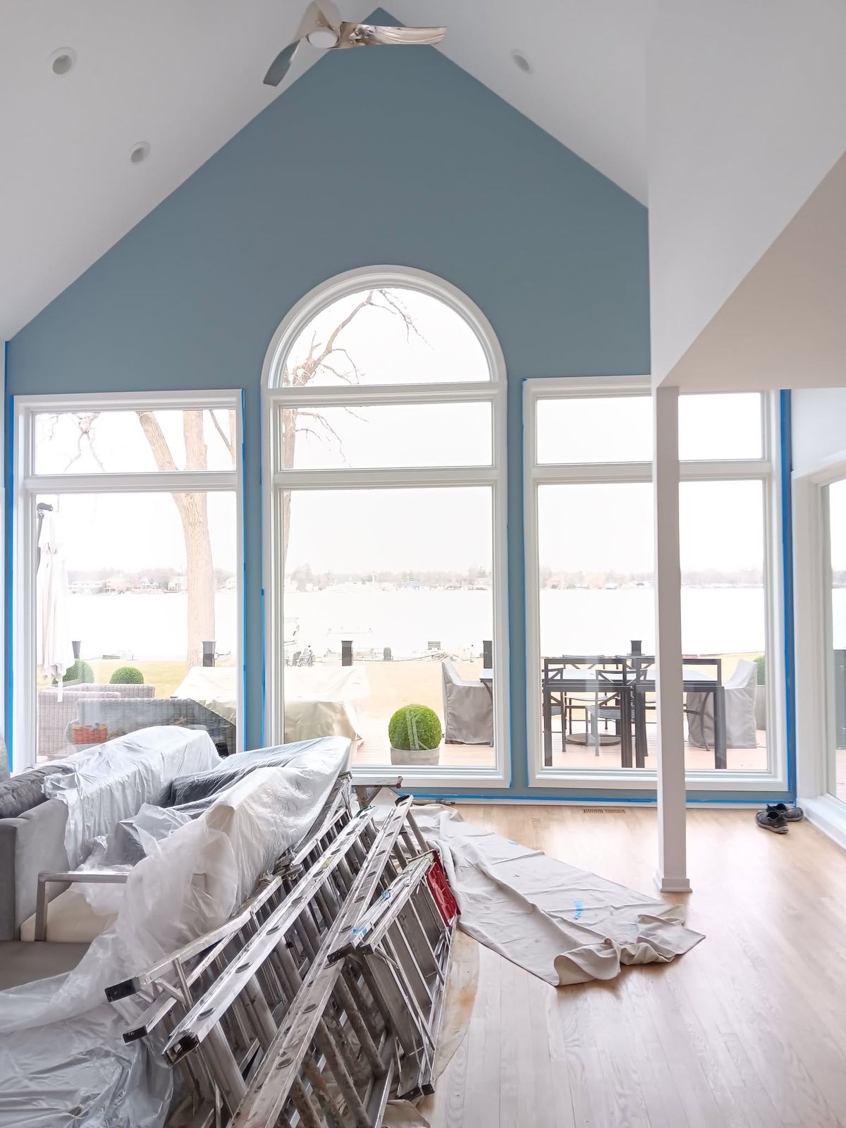 Great room repaint in progress, trim masked and floors covered